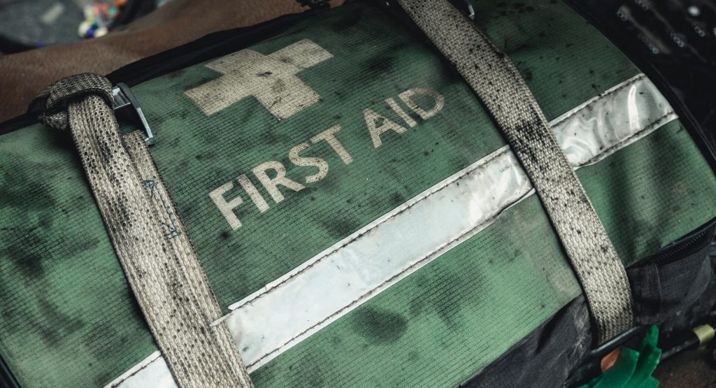 Image of an old first aid kit, potentially containing medical supplies for emergencies, a must-have gear for every hiker.